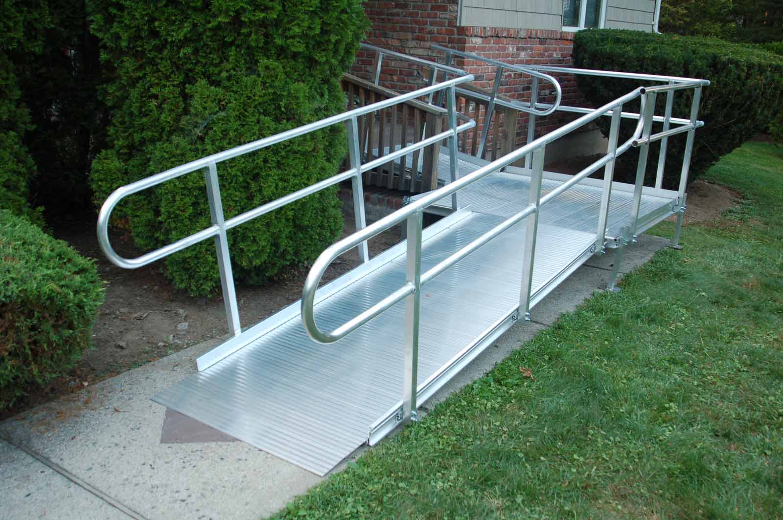 Aluminum Wheelchair Ramp Installation Leading onto a Wooden Home Deck