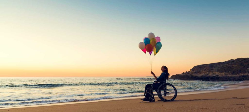 ADA 30th Anniversary - Lady in Wheelchair with Balloons on the Beach