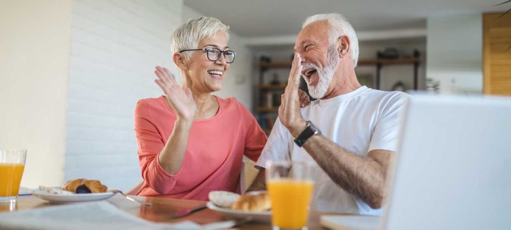 Elderly Couple High Fiving at Breakfast