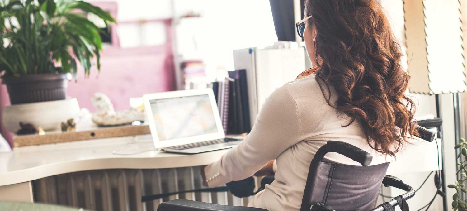 Middle-Aged Adult Woman Working and in Wheelchair