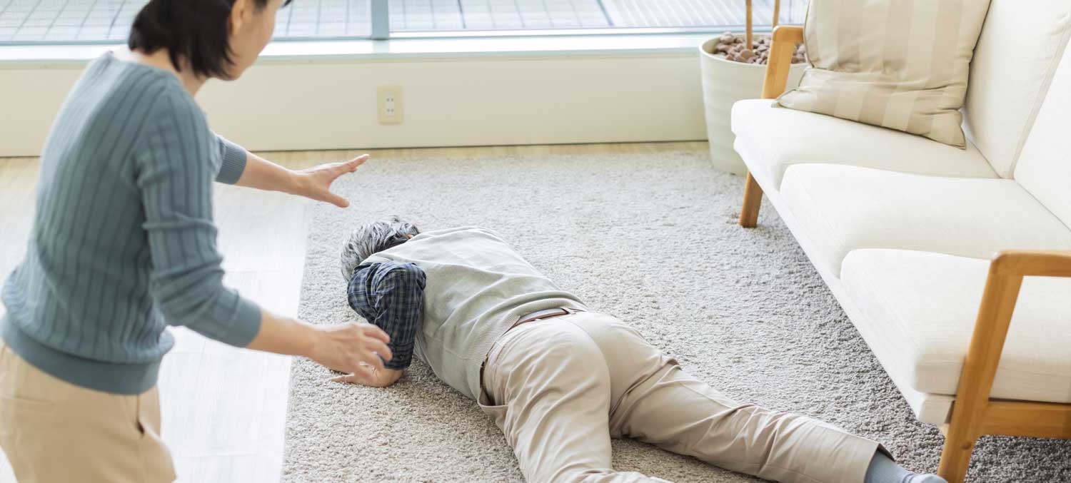 Woman Standing Over a Man Having a Heart Attack