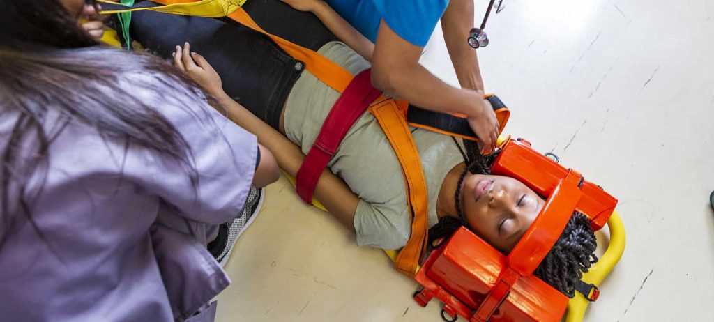 Spinal Cord Injury - Girl Lying on the Floor in a Stretcher