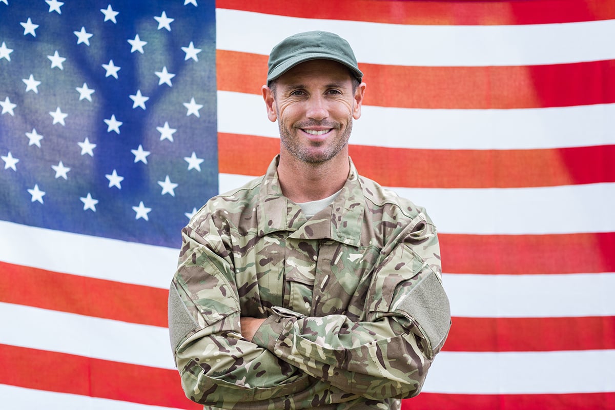 Veteran standing in front of the American flag