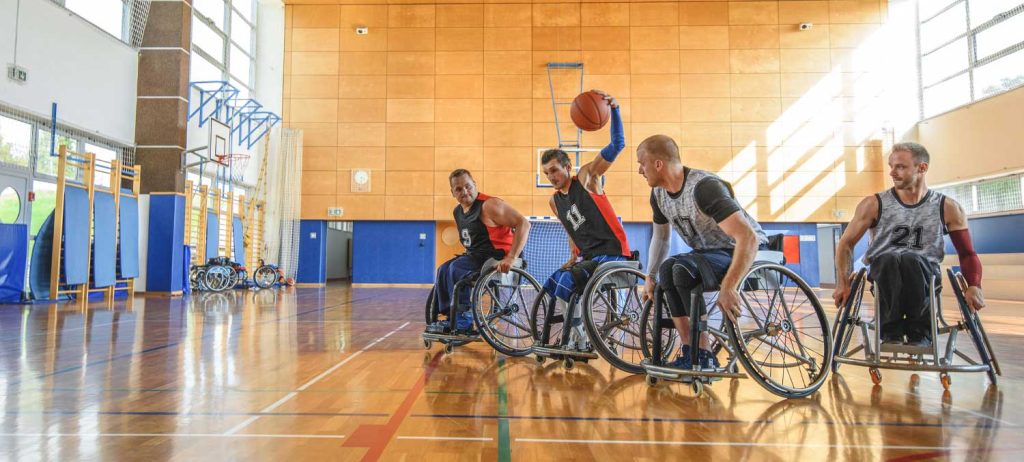 Wheelchair Basketball Game with Disabled Men on a Court