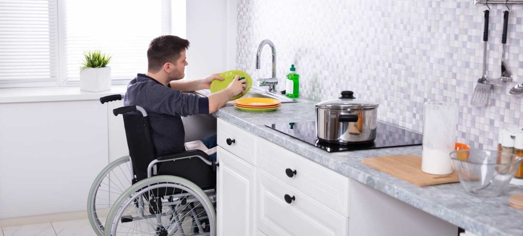 Man in Kitchen with a Wheelchair