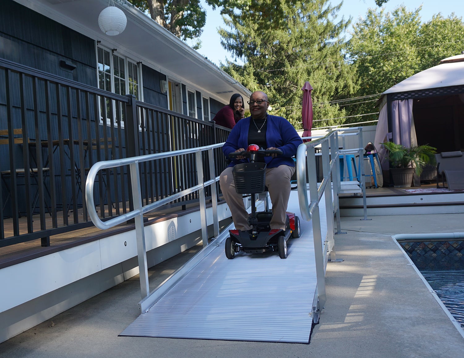 Woman going down an access ramp on a mobilized scooter