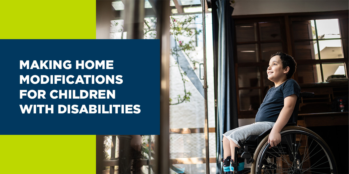 Young boy in wheelchair looking out a glass door