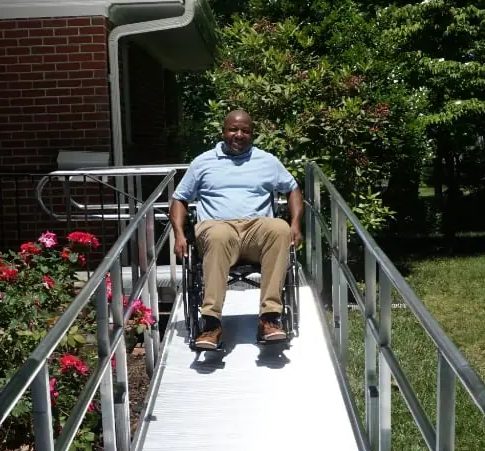 Gentleman in a wheelchair using a National Ramp wheelchair ramp