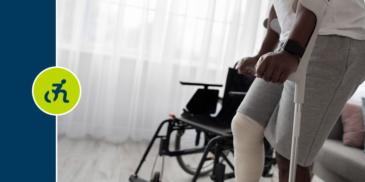 Man walking with a crutches due to an injured leg