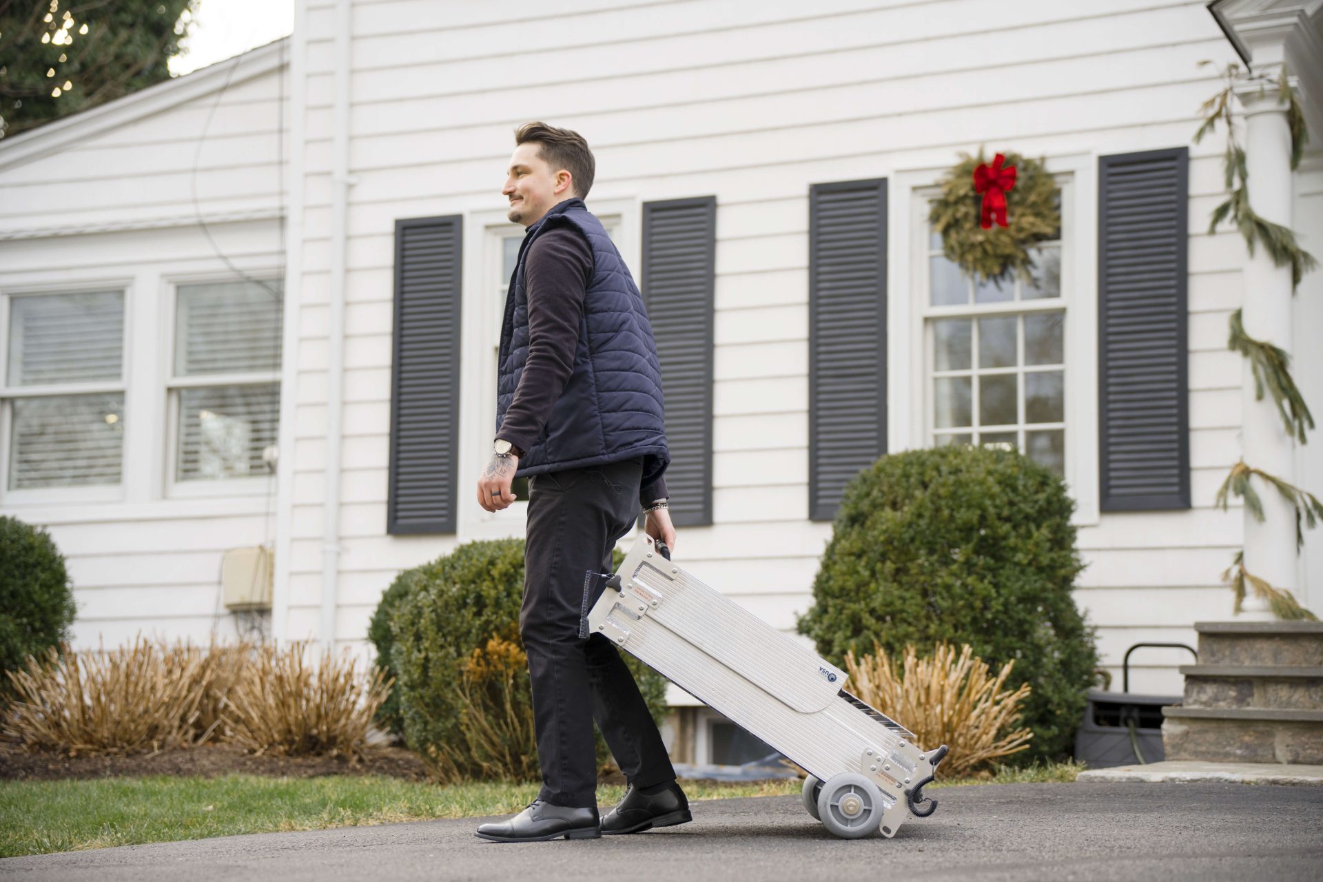 Gentleman pulling a portable fold-up wheelchair ramp